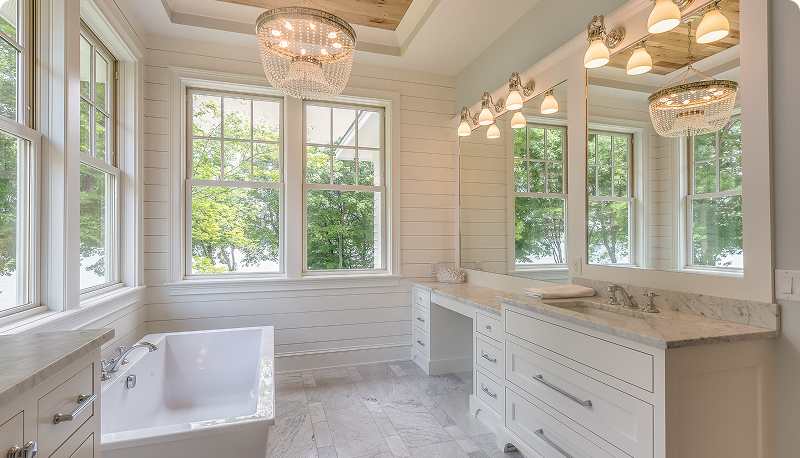 Bright, elegant bathroom with large windows and modern lighting.