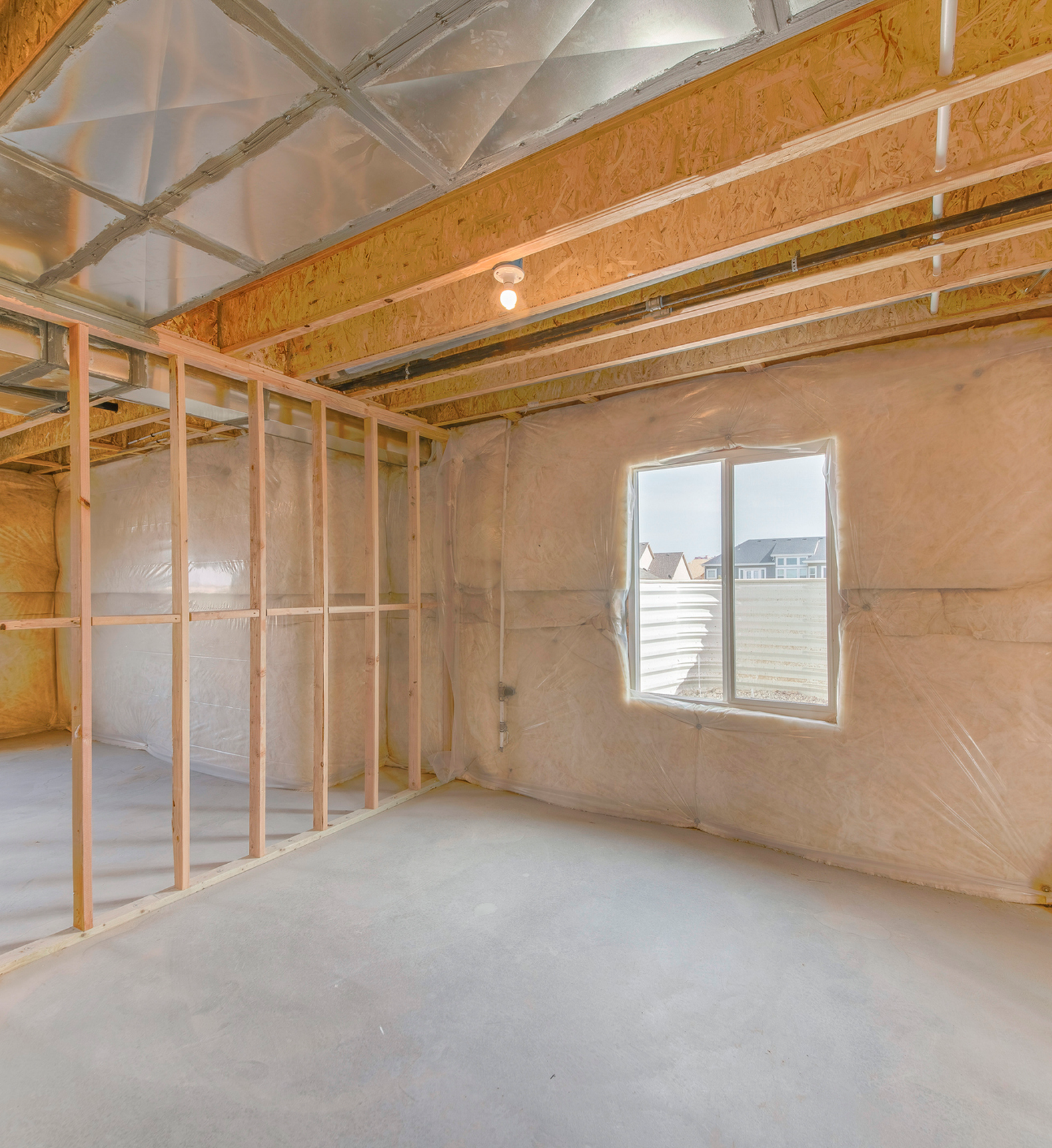 Unfinished room with exposed wooden framing and insulation.