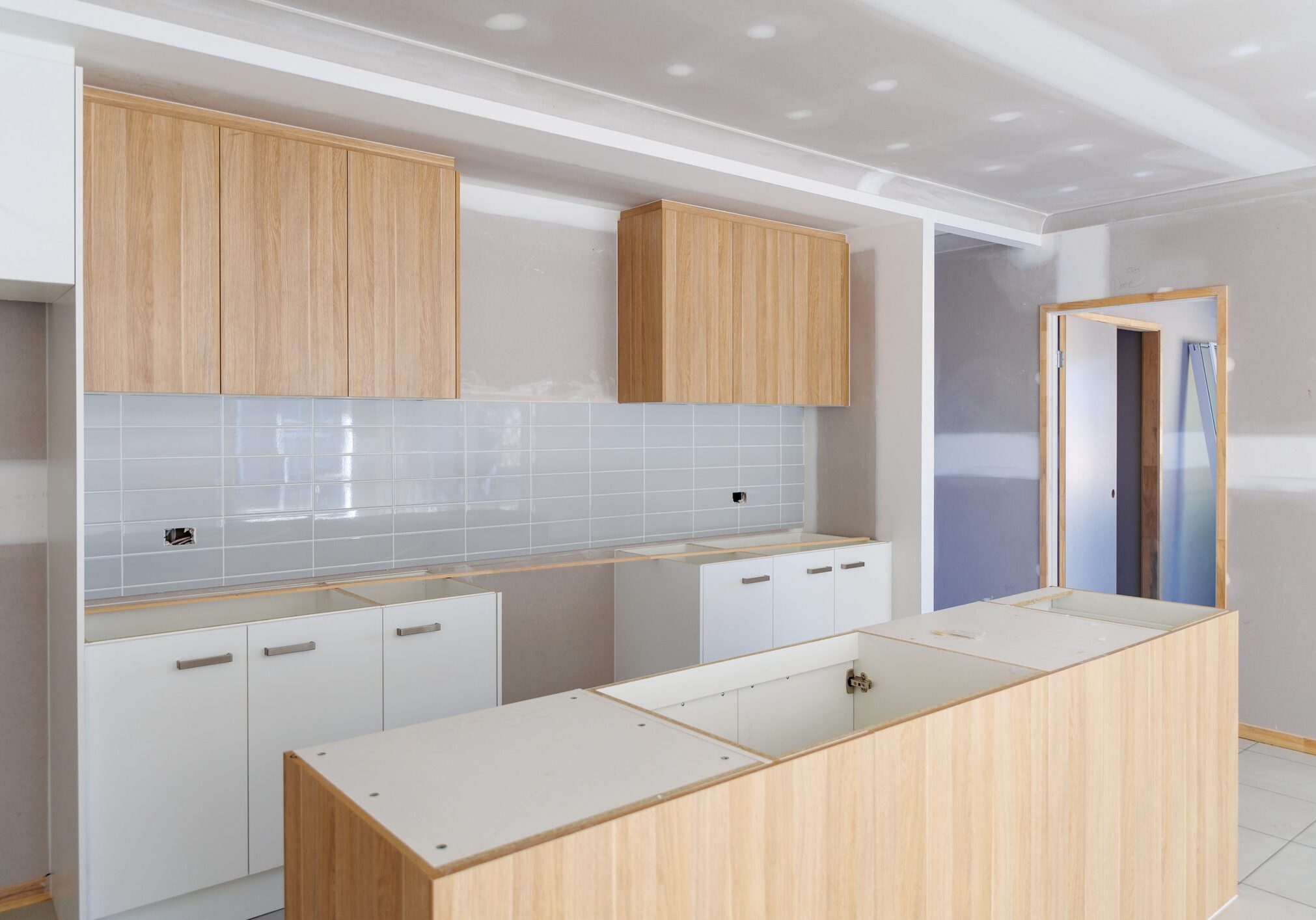 Modern kitchen with wooden cabinets and a large island.
