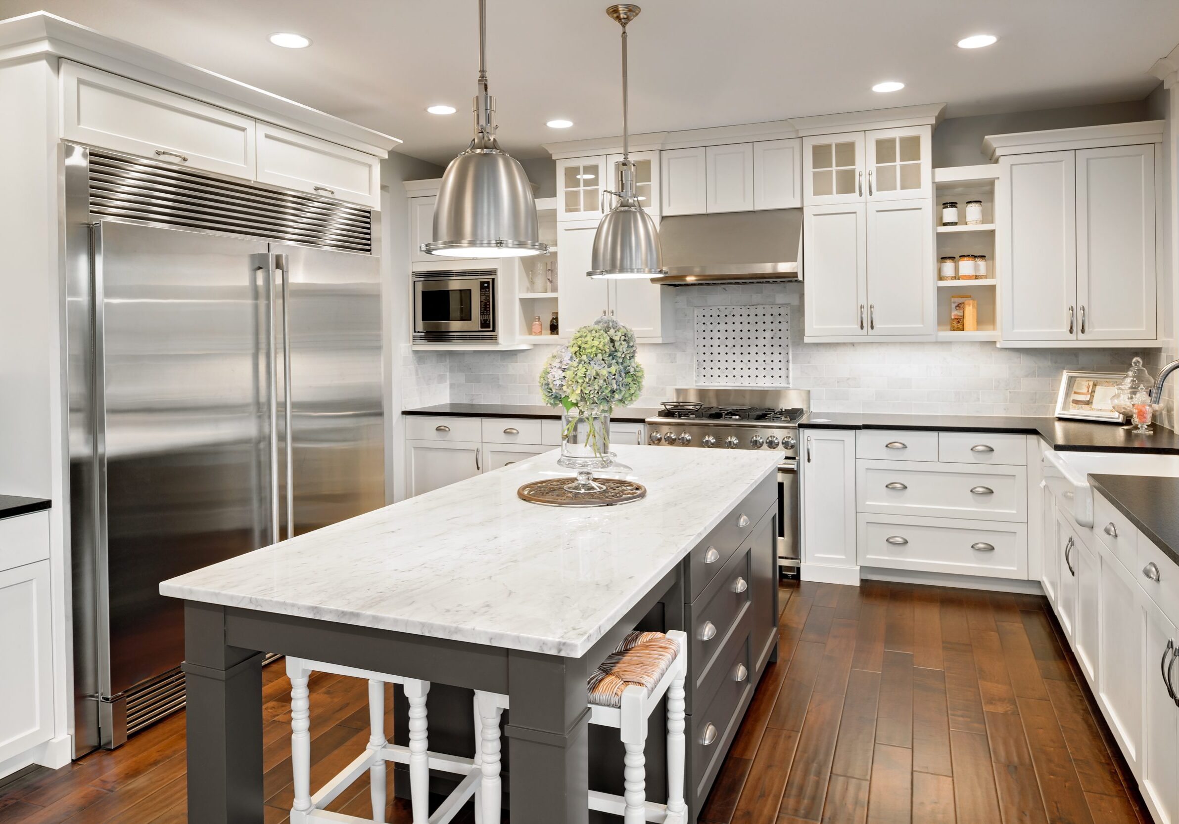 Modern white kitchen with marble island, stainless appliances